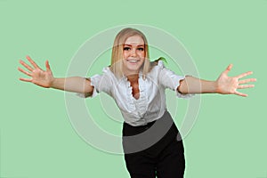 Young beautiful woman with her hands wide apart on the green screen