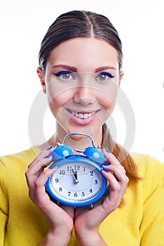 Young beautiful woman holding big and small clocks