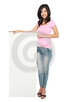 Young beautiful woman holding blank white card