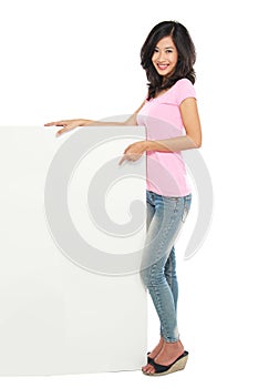 Young beautiful woman holding blank white card