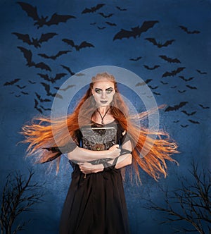 young beautiful woman holding a book about witchcraft in her hands, a witch conjures on Halloween. photo