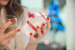 Young beautiful woman holding Chrismtas present in her hands