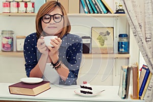 Young beautiful woman holding coffee cup was smell fragrant in c