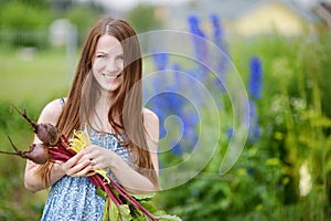 Young beautiful woman holding fresh vegetables