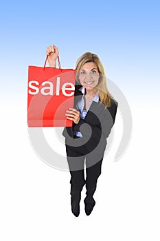 Young beautiful woman holding sale red shopping bag