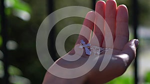 Young beautiful woman holding silver cross in hands. Christianity religion.