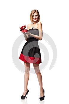 Young beautiful woman holding small red box. Studio portrait iso