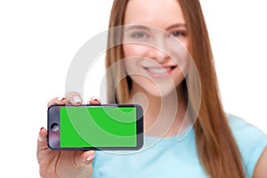 Young beautiful woman holding smartphone with copyspace