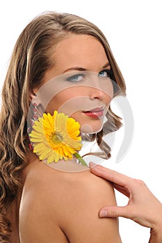 Young Beautiful woman holding a yellow flower