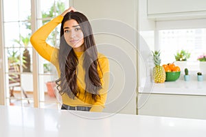 Young beautiful woman at home on white table confuse and wonder about question