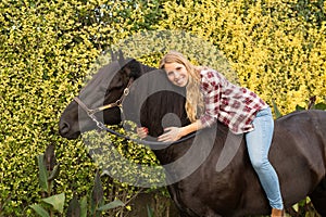 Young beautiful woman with a horse