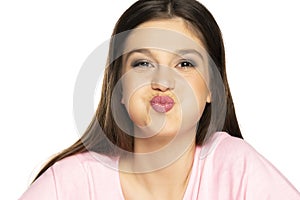 Young beautiful woman with  inflated cheeks