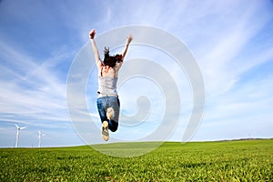 Young beautiful woman jumping for joy