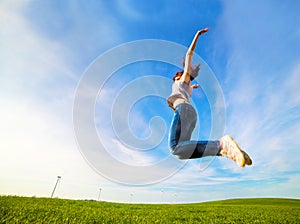 Young beautiful woman jumping for joy