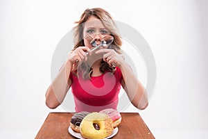 Young beautiful woman with knife and fork crossed