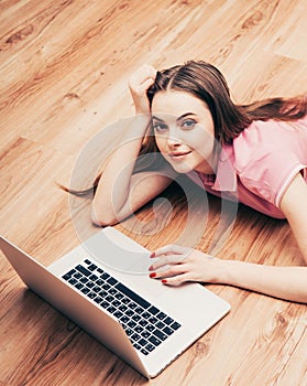 Young beautiful woman with laptop notebook on floor home surfing internet