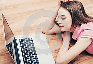 Young beautiful woman with laptop notebook on floor home surfing internet
