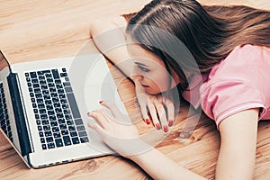 Young beautiful woman with laptop notebook on floor home surfing internet