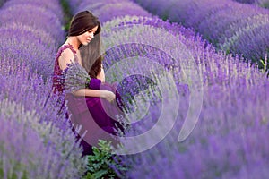 Young beautiful woman in lavender fields with a romantic mood photo