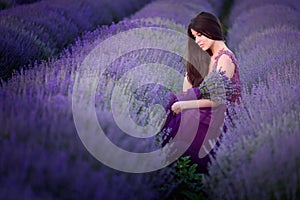 Young beautiful woman in lavender fields with a romantic mood