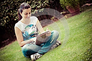 Young beautiful woman lays on green field