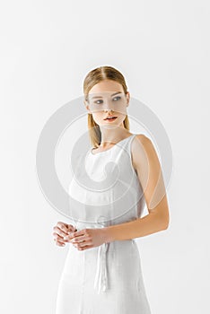 young beautiful woman in linen white dress looking away
