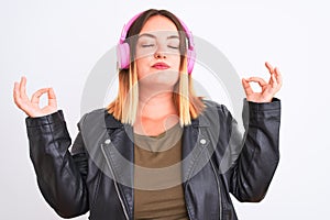 Young beautiful woman listening to music using headphones over isolated white background relax and smiling with eyes closed doing