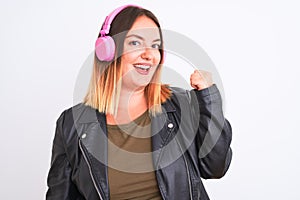 Young beautiful woman listening to music using headphones over isolated white background smiling with happy face looking and