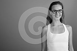 Young beautiful woman with long blond hair against gray background