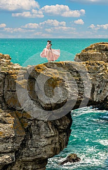 Young beautiful woman with long dress ,romantic mood on the Black sea side Tulenovo Bulgaria