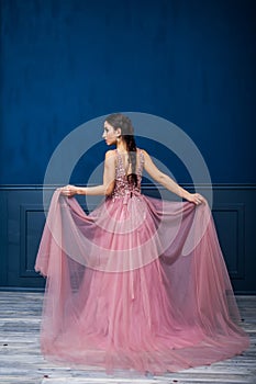 Young beautiful woman in long stylish evening dress