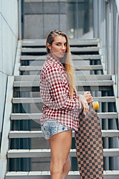 Young beautiful woman with longboard