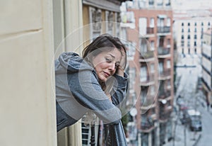 Young beautiful woman looking sad and depressed on a balcony in a depression concept