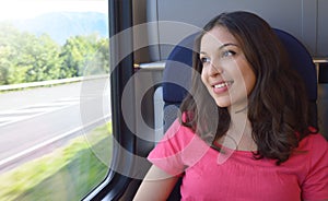 Young beautiful woman looking through the train window.