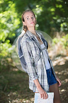 Young beautiful woman lost in forest