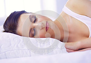 Young beautiful woman lying in bed.