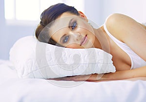 Young beautiful woman lying in bed.