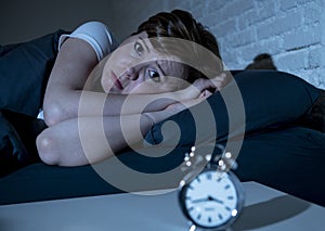 Young beautiful woman lying in bed late at night suffering from insomnia trying to sleep