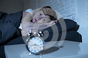 Young beautiful woman lying in bed late at night suffering from insomnia trying to sleep