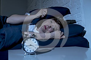 Young beautiful woman lying in bed late at night suffering from insomnia trying to sleep