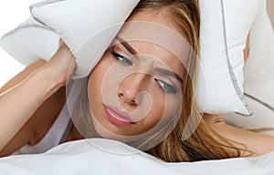 Young beautiful woman lying in bed suffering with insomnia