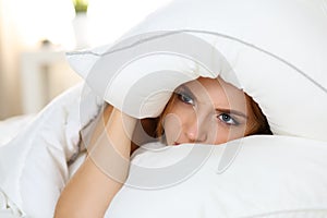 Young beautiful woman lying in bed suffering with insomnia