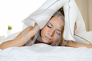 Young beautiful woman lying in bed suffering with insomnia