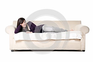Young beautiful woman lying on sofa isolated