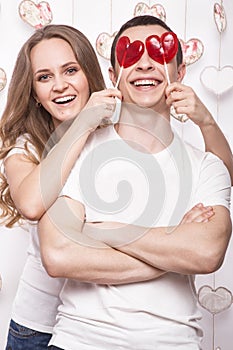 Young, beautiful woman and man in love on Valentine's Day with candy, Laughing Happy Lovers, showing different poses.