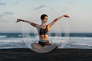 young beautiful woman meditation on beach.