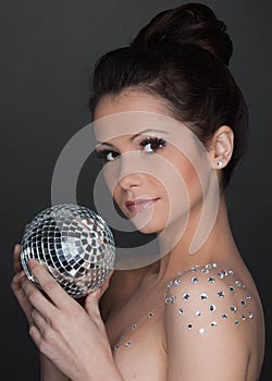 Young beautiful woman with mirrored ball