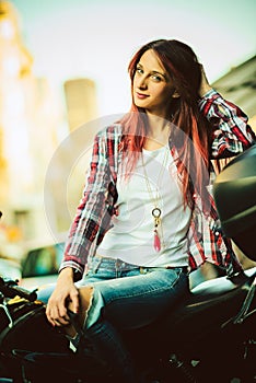 Young beautiful woman on motorcycle