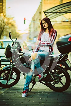 Young beautiful woman on motorcycle