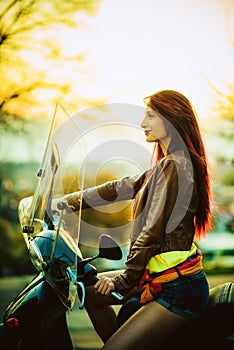 Young beautiful woman on motorcycle